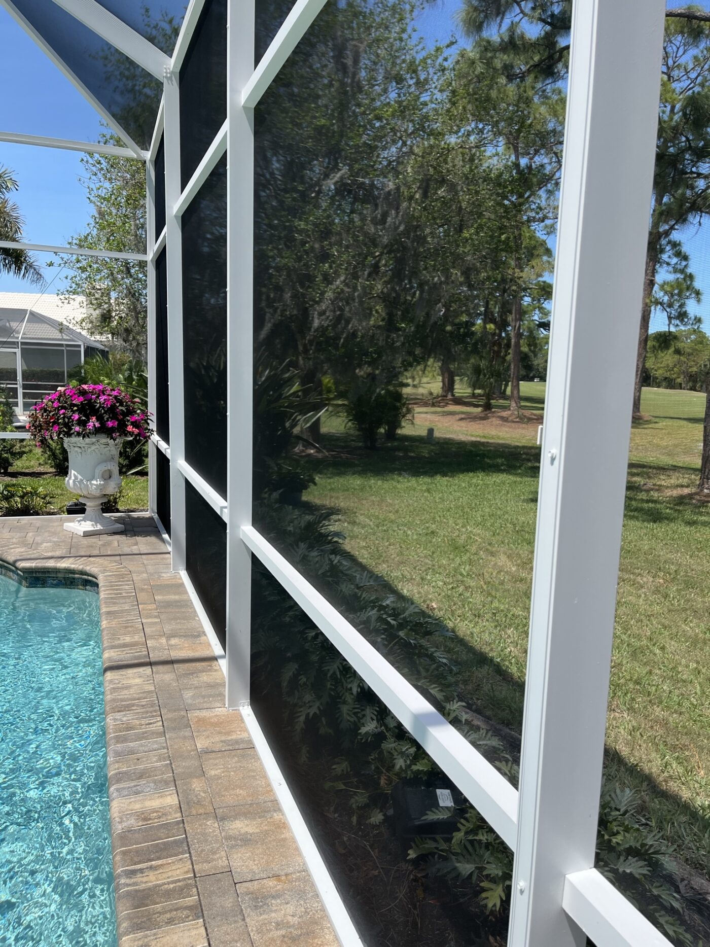 Pool cage painting and -re-screening white color using Sherwin Williams DTM and Phifer Screen, Panoramic Views and Two story Pool Enclosure Restorations